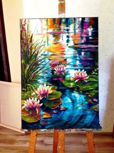 an easel with a painting on it that has water lillies in the pond