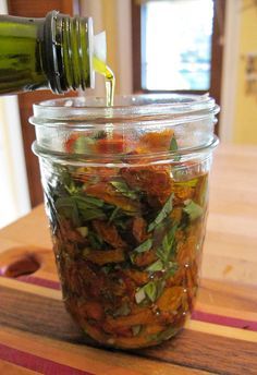 a jar filled with food sitting on top of a wooden table