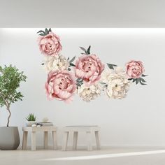 a white room with pink flowers on the wall