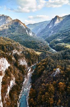 an aerial view of a river flowing between two mountains