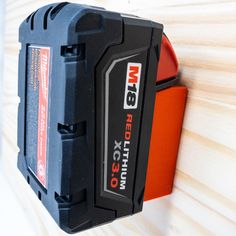 a black and red tool box mounted to a wall