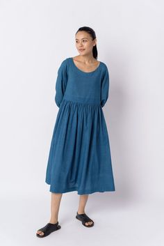 Effortless elegance in this indigo midi dress with waist gathers, a relaxed fit, and a gentle scoop neckline. Crafted from soft textured cotton, it offers year-round comfort and versatility for your everyday style. Knee-length Cotton Midi Dress With Gathered Waist, Spring Midi Dress For Gatherings, Midi Dress With Gathered Neckline For Gatherings, Casual Linen Dress With Gathered Waist, Spring Dresses With Gathered Skirt For Gatherings, Knee-length Ruched Relaxed Fit Dress, Relaxed Fit Ruched Knee-length Dress, Relaxed Fit Knee-length Ruched Dress, Ruched Relaxed Fit Knee-length Dress