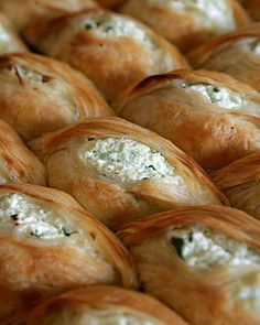 several rolls with cheese and spinach on them