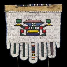 a piece of cloth with designs on it and fringes hanging from the side,