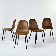 three brown chairs with black legs are lined up in a row