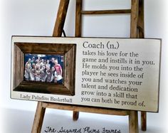 a wooden easel with a plaque on it that reads coach n takes his love for the game and instills it in you