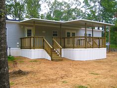 a mobile home with stairs leading to the front porch