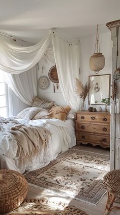 a bedroom with white walls and lots of natural light in the room, including a canopy bed