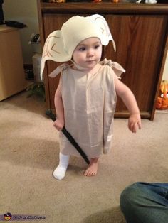 a small child in a costume holding a baseball bat