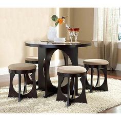 a dining room table with four stools