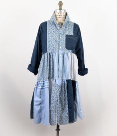 a blue and white shirt dress on a mannequin headdress with buttons