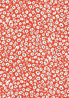 an orange and white floral pattern with black dots on the bottom half of the image