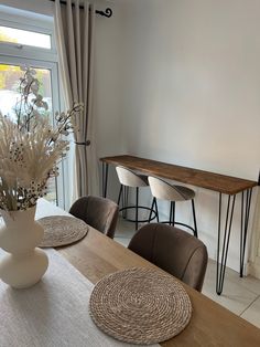 a dining room table with place mats on it