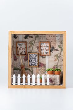 a wooden frame with pictures and plants on it