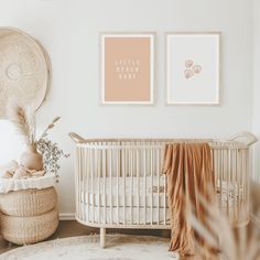 a baby's room with two pictures on the wall