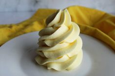 a white plate topped with sliced bananas on top of a yellow cloth next to a banana peel