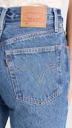 Fitted Blue Jeans With Patch Pockets, Levi's Medium Wash Bottoms, Levi's Medium Wash Bottoms With Five Pockets, Fitted Jeans With Hip Pockets For Spring, Levi's Tapered Leg Medium Wash Jeans, Fitted Medium Wash Jeans With Hip Pockets, Classic Medium Wash Jeans With Hip Pockets, Levi's High Waist Dark Wash Jeans, Levi's Classic Denim Bottoms