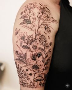 a woman's arm with flowers and butterflies tattoo on the left side of her body