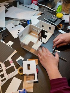 a person is working on some model houses