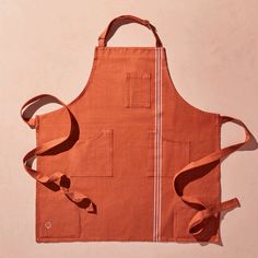 an orange apron with two straps hanging from it