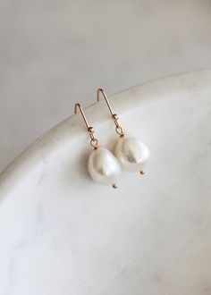 The ultimate pearl drop for minimalist brides, the Lara earrings feature luminous freshwater pearls that are striking in their simplicity and timeless in their silhouette.Available in silver or gold tones. Please leave your colour preference in the message box at checkout.• DETAILS •> Designed in Australia. Worldwide shipping> Silver or gold plated findings, freshwater pearls> Dimensions: 26mm length (11-12mm pearl)> Colour: Silver or gold tones• READY TO SHIP •The Lara earrings are ready to shi Timeless Dangle Bridal Earrings For Wedding, Minimalist Pearl Drop Bridal Earrings, Minimalist Drop Earrings For Wedding, Timeless Teardrop Bridal Earrings For Wedding, Minimalist Pearl White Pearl Drop Bridal Earrings, Minimalist Pearl White Bridal Earrings With Pearl Drop, Minimalist Pearl Drop Wedding Earrings, Minimalist Wedding Pearl Drop Earrings, Minimalist Pearl White Pearl Earrings For Wedding