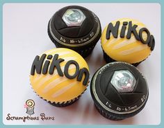 four cupcakes decorated with the word niko and soccer balls on top of them