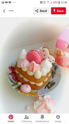 there is a small cake on the plate next to it's box and some candies