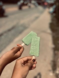 a person holding an ice lolly on a stick in their hand with the number one