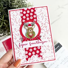 someone holding up a card with a deer on it