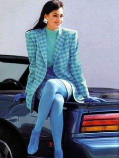 80s fashion, young smiling brunette with big square earrings, sitting on a blue retro convertible car, wearing a checked blue skirt suit with oversize blazer, opaque blue tights blue shoes and blue gloves 1980s Fashion Trends, Fashion 1980s, Dorothy Dandridge, Blue Tights, Djerf Avenue, 80s Women