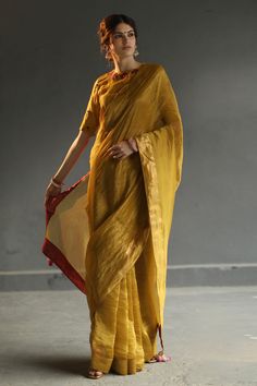 Mustard yellow sheen saree with contrasting border along with ombre tassels. Paired with charcoal grey antique weaved blouse with hand embroidered buttis around the neck.
Component: 2
Embroidered
Neckline: Round
Sleeve Length: Elbow
Fabric: Tissue
Color: Yellow
Back button closure with keyhole
Hand embroidered buttis on the blouse, hand made tassels, and hand woven zari - Aza Fashions Haldi Dress, Tissue Saree, Blouse For Women, Embroidered Neckline, Saree Look, Saree With Blouse, Blouse Online, Green Silk, Embroidered Silk