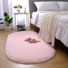 a bedroom with a pink rug on the floor