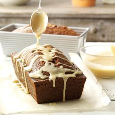 a loaf of bread being drizzled with icing