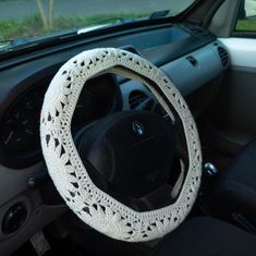 the steering wheel cover is crocheted with white yarn