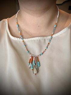 Handmade Summer Vibes Beaded Fringe Necklace. Coral, blue, white, and turquoise beads with a handmade Fringe Pendant. This necklace is so happy and vibrant! Clasp is handmade with 38mm antique copper plated ball pins. Necklace measures approximately 22 inches. Handcrafted items are just that, hand-made, some items may have variations in glass, stone, texture, or crimps. If you have any sizing concerns or questions, please message me ❤. Go Here for Jewelry Sizing Help! Artisan Necklace With Spacer Beads For Beach, Handmade Bohemian Shell Necklace With Round Beads, Bohemian Blue Shell Necklace For Jewelry Making, Bohemian White Necklaces With Dangling Beads, Hippie White Beaded Jewelry, White Bohemian Necklaces With Dangling Beads, Blue Hippie Beaded Necklaces, White Beaded Hippie Jewelry, Bohemian White Beaded Necklaces With Dangling Beads