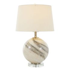 a marble lamp with a white shade on it