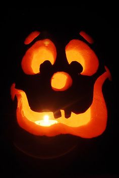 a carved pumpkin with glowing eyes and mouth