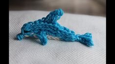 a close up of a piece of blue and white yarn on top of a pillow