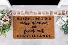 a door mat that says, this house is protected by mess around and find out surveillance