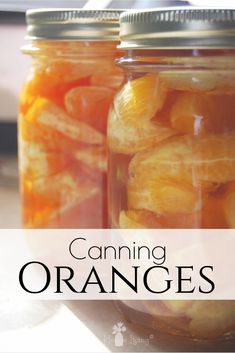 two jars filled with orange slices on top of a table