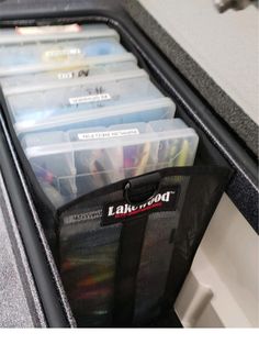 there are many plastic containers in the back of this car seat belt organizer case that holds pens, pencils and other office supplies