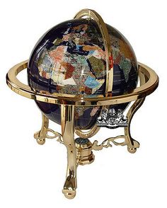 a decorative globe on a stand with gold trimmings and multicolored tiles