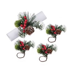 three christmas decorations with pine cones and berries