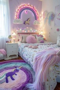 a bedroom decorated in pastel colors with unicorn rugs and lights on the walls