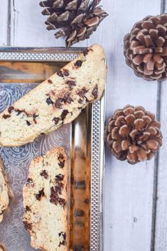 chocolate chip scones on a metal tray next to pine cones and fircons