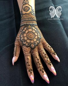 a woman's hand with henna tattoos on it and the words, mehnish