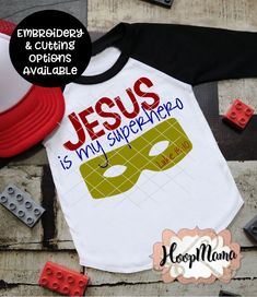 a baseball shirt with the words jesus is my super hero on it next to legos