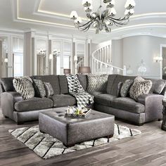 a living room filled with furniture and a chandelier