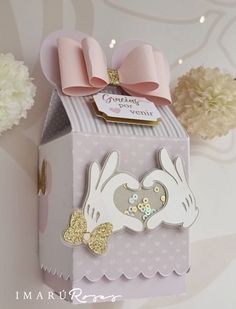 a small box with a pink bow on it