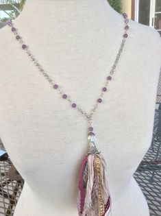 This whimsical necklace is made with sari silk, ribbon and lace.  The 6mm purple beads are lepidolite and the chain and toggle clasp are silver plated.  There is one faceted iridescent bead that catches the light beautifully.  The total length is 40 inches. Bohemian Silver Amethyst Beaded Necklace, Purple Bohemian Beaded Chain Necklace, Bohemian Purple Beaded Chain Necklace, Bohemian Lavender Beaded Crystal Necklace, Adjustable Bohemian Lavender Crystal Necklace, Sari Silk Necklace, Whimsical Necklace, Sari Silk Ribbon, Silk Necklace